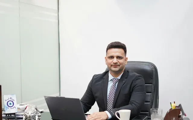 Business owner working on a laptop in his office