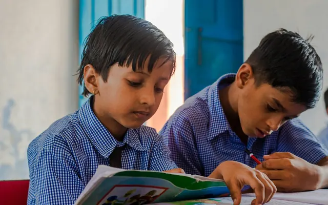 Two school boys reading at their desk