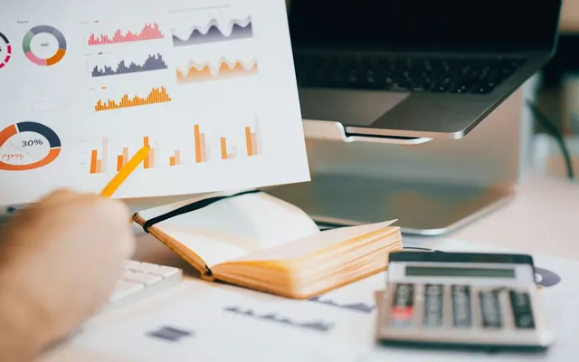 Printed report pages with charts on a desk