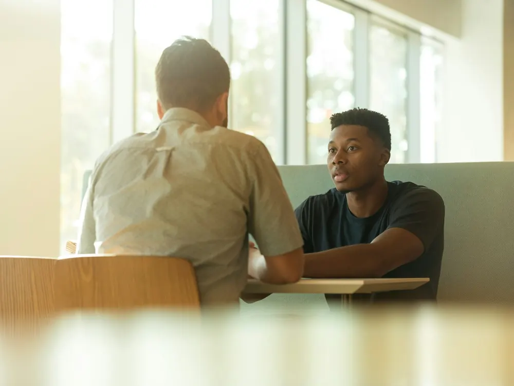 Two people in a one-to-one conversation